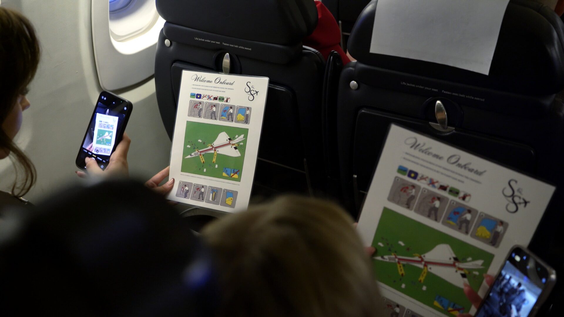 video still of personalised safety cards on board of concorde wedding