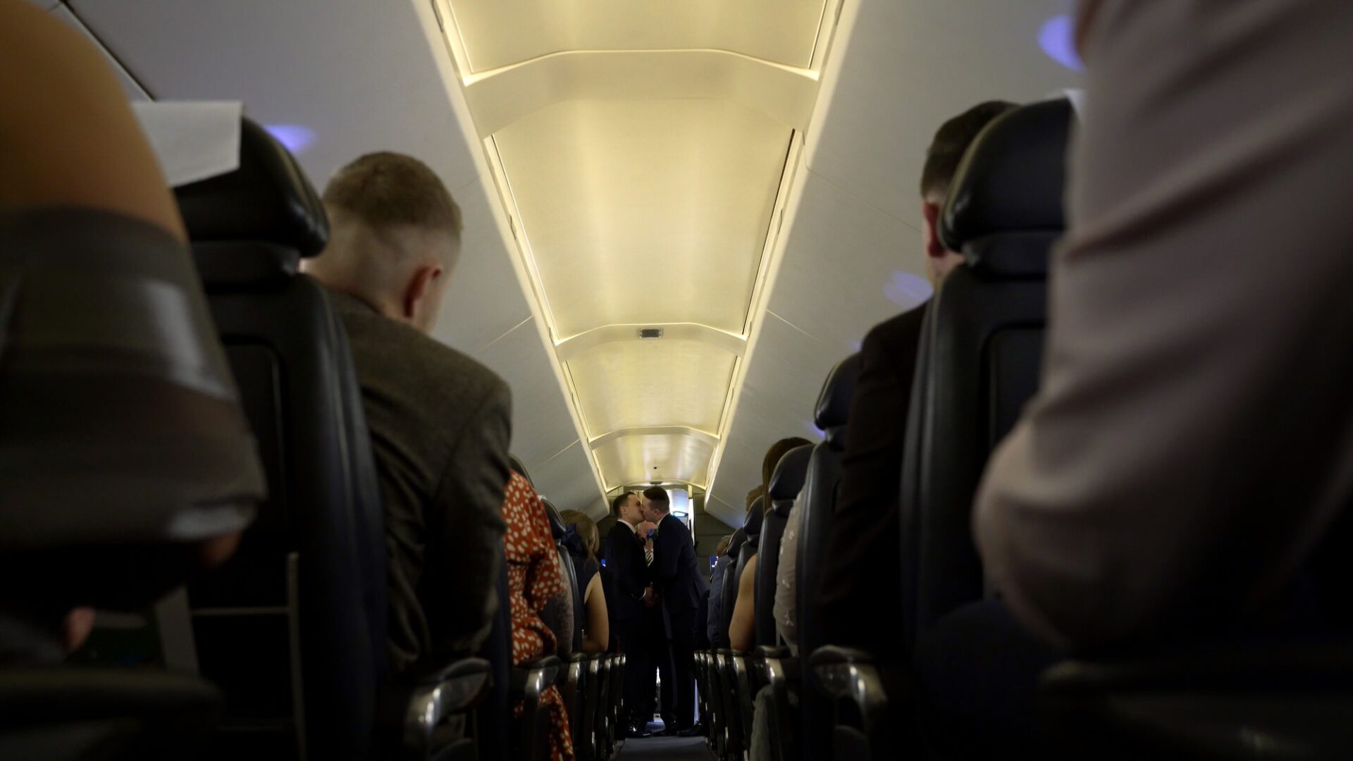 couple kiss and guests cheer during wedding at Concorde Manchester
