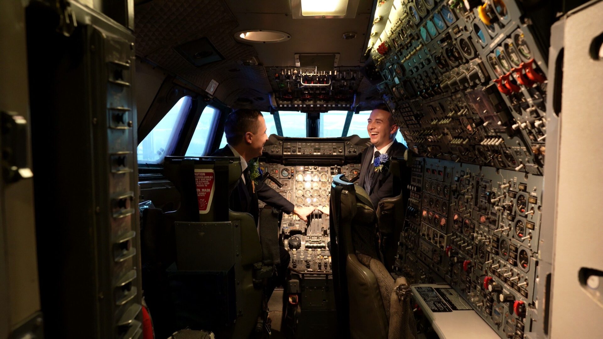 a newlywed couple sit in the Concorde cockpit for photos and video