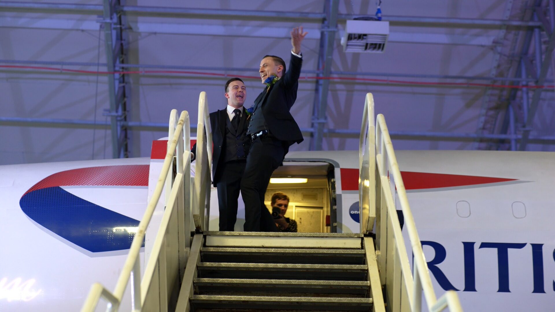grooms dance out of Concorde for a fun wedding video