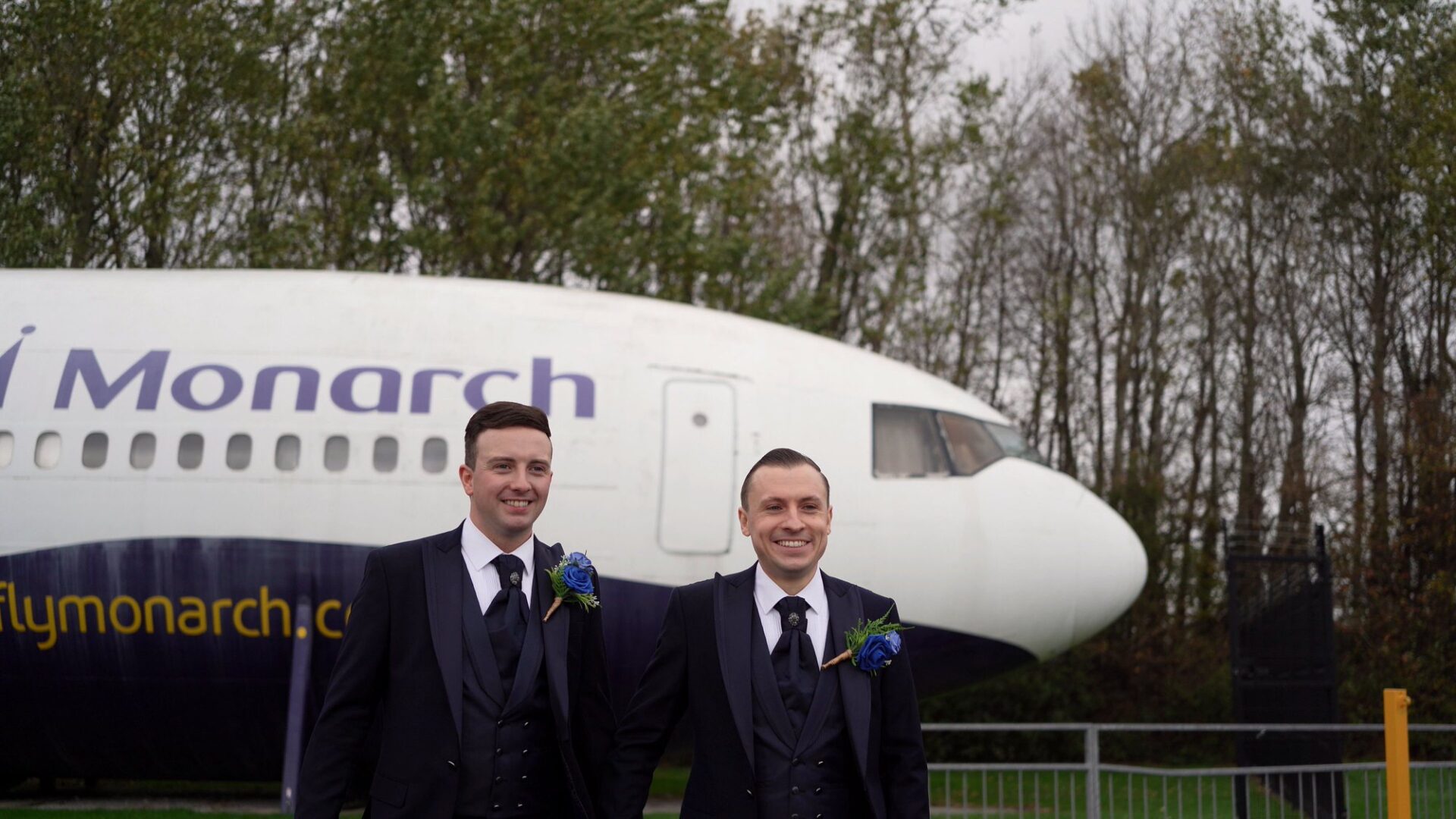a couple pose casually by the Monarch plane at Runway Visitor Park