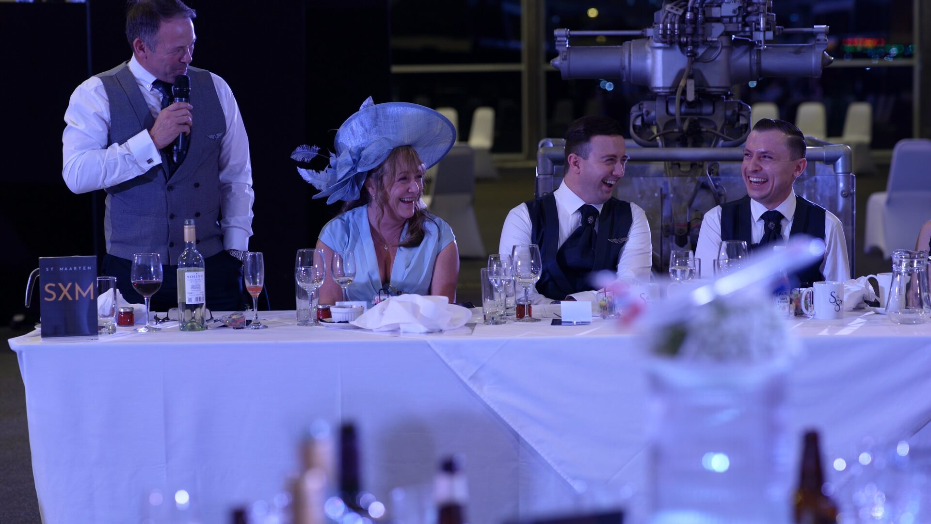 top table laugh during father of the groom speech under Concorde