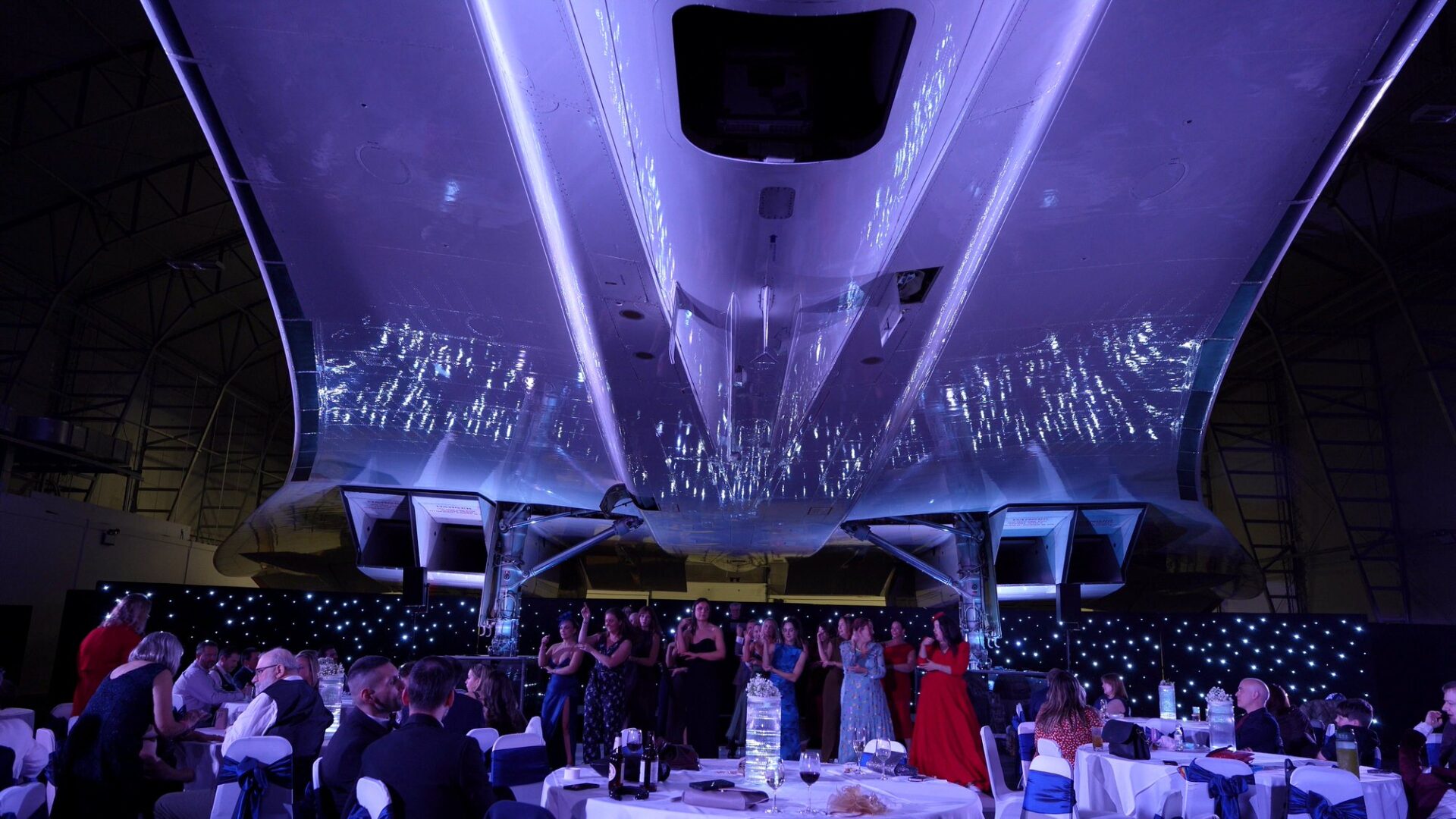 guests dance under the belly of Concorde during a wedding in Manchester