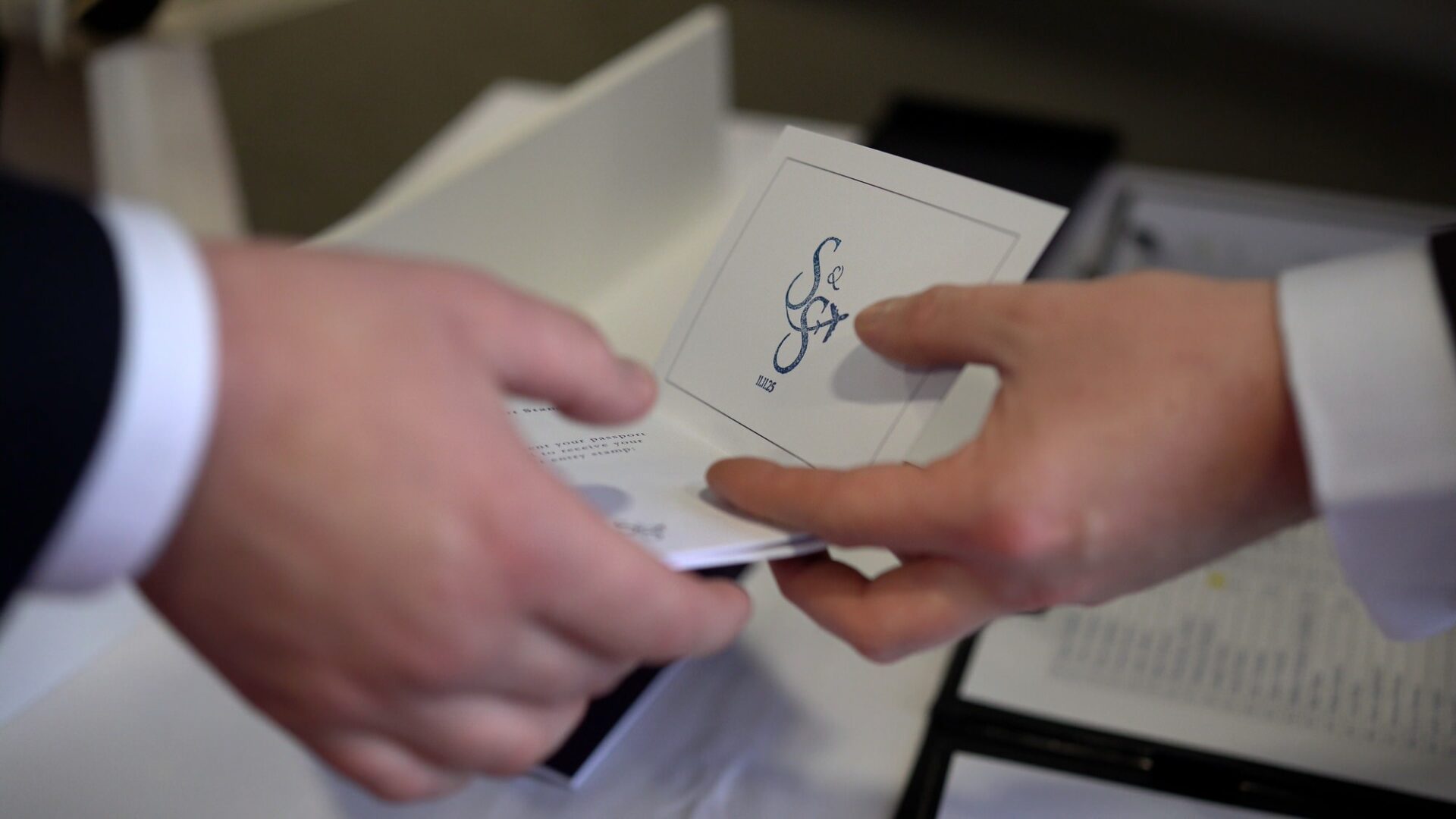 a close up video shot of the personalised wedding passport being stamped