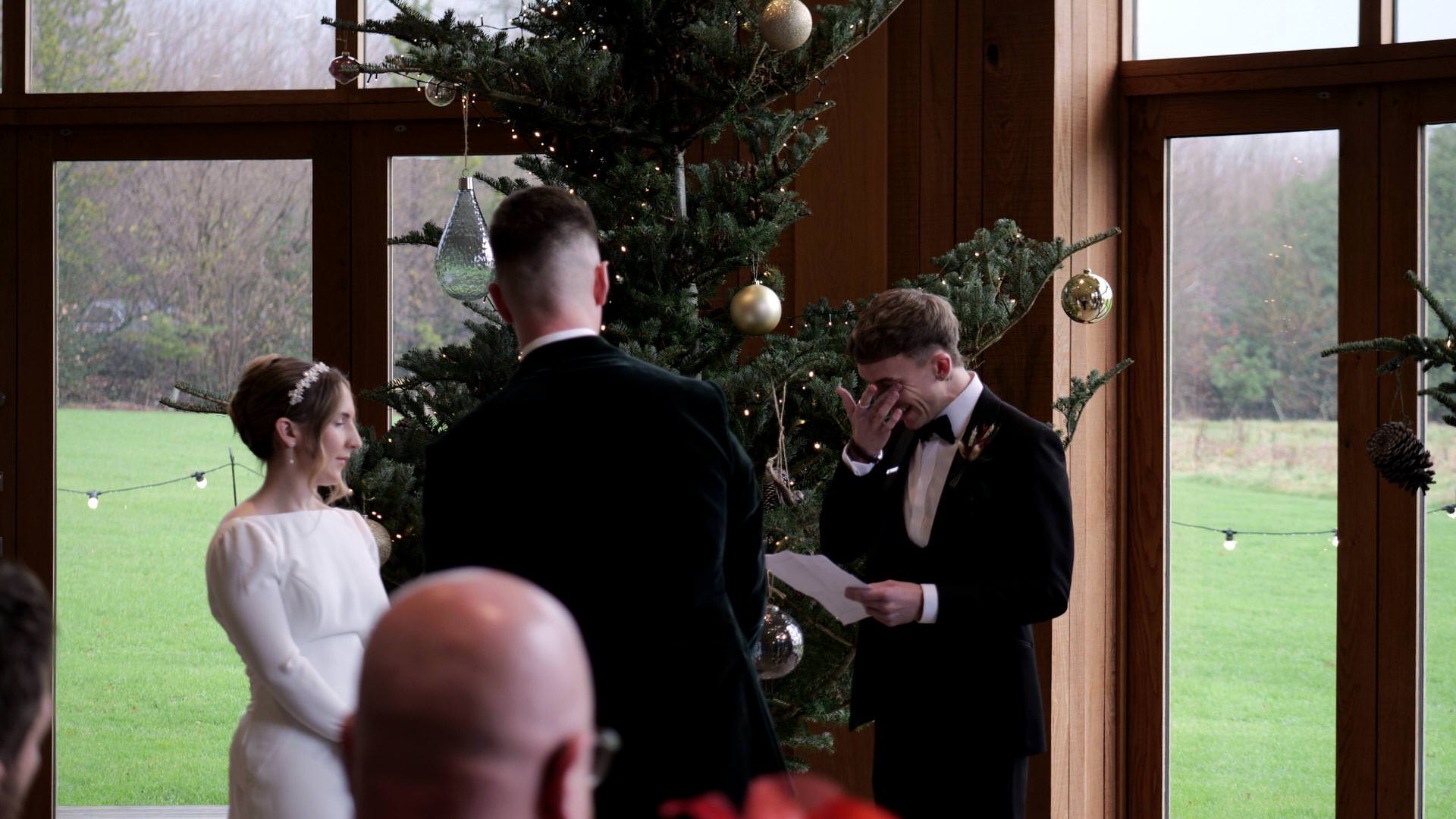 video still of an emotional reading during a winter wedding ceremony at the Out Barn