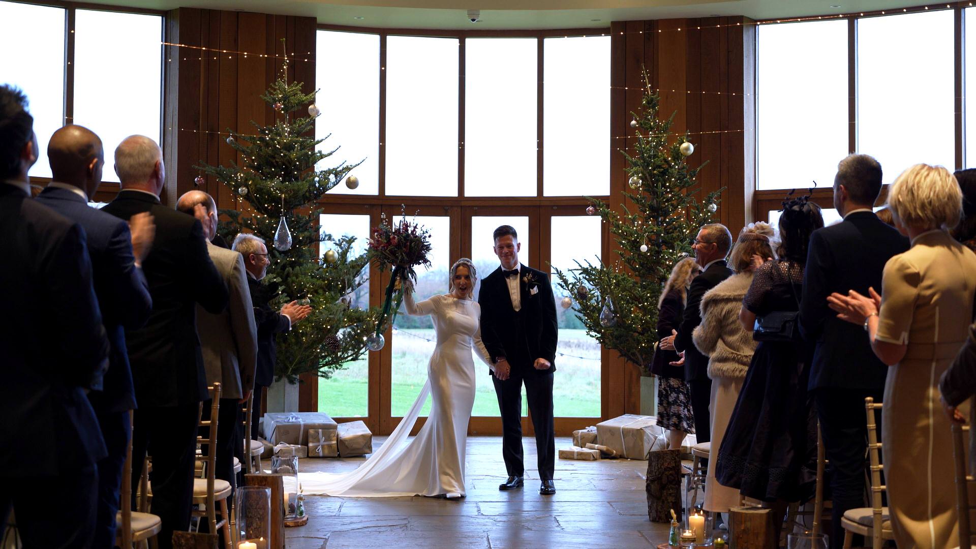 the couple dance back down the aisle at the Out Barn