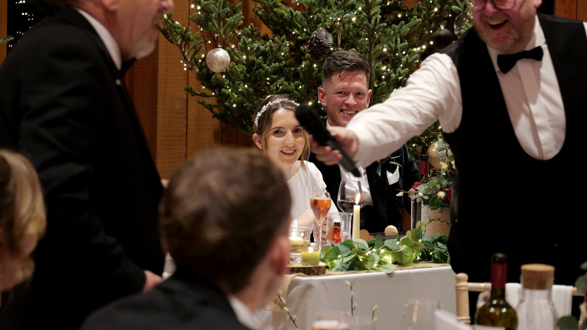 a mic is handed over to the father of the bride for his speech