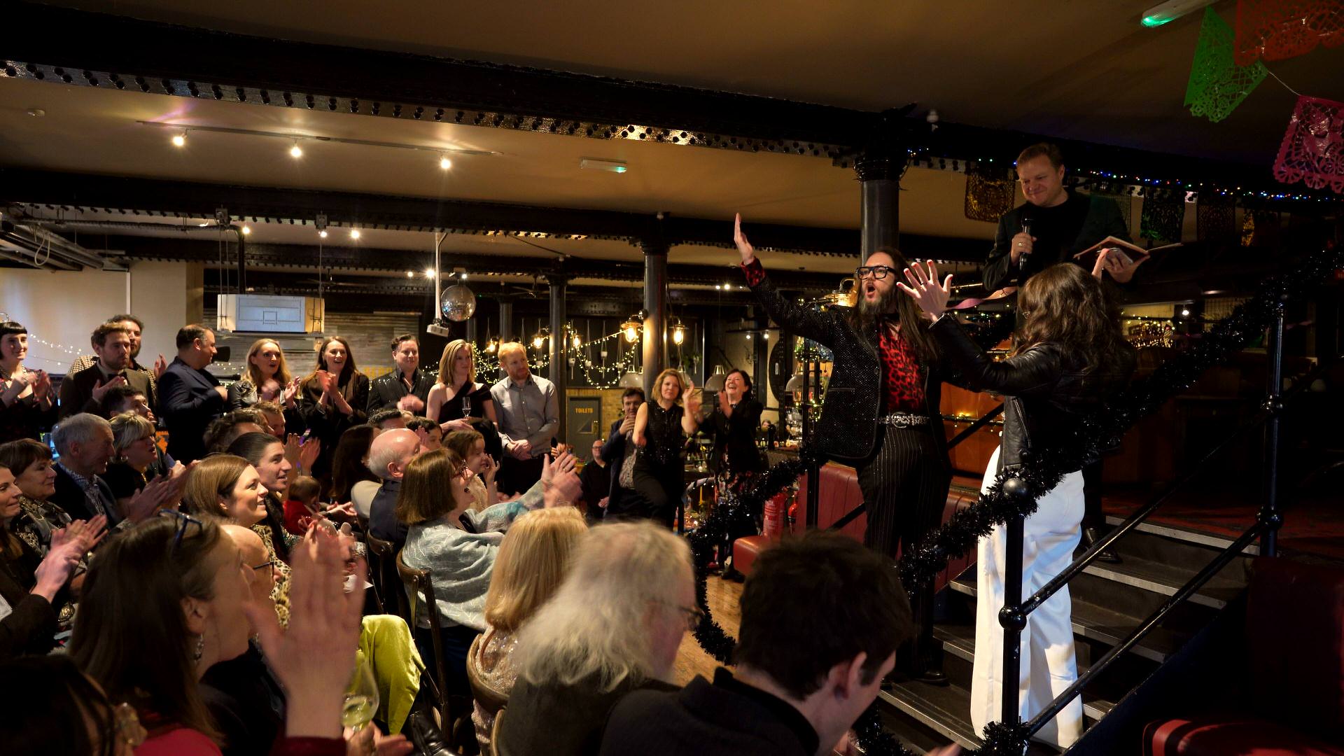 the couple and guests cheer as their announced husband and wife