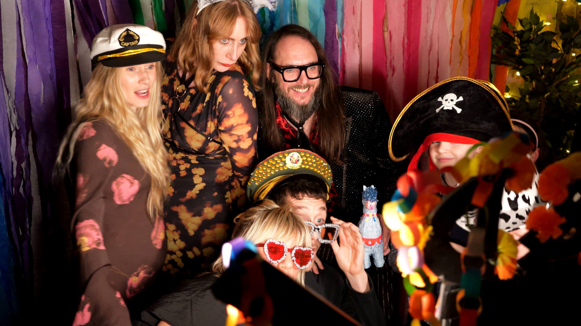 the groom and friends enjoy the homemade photobooth