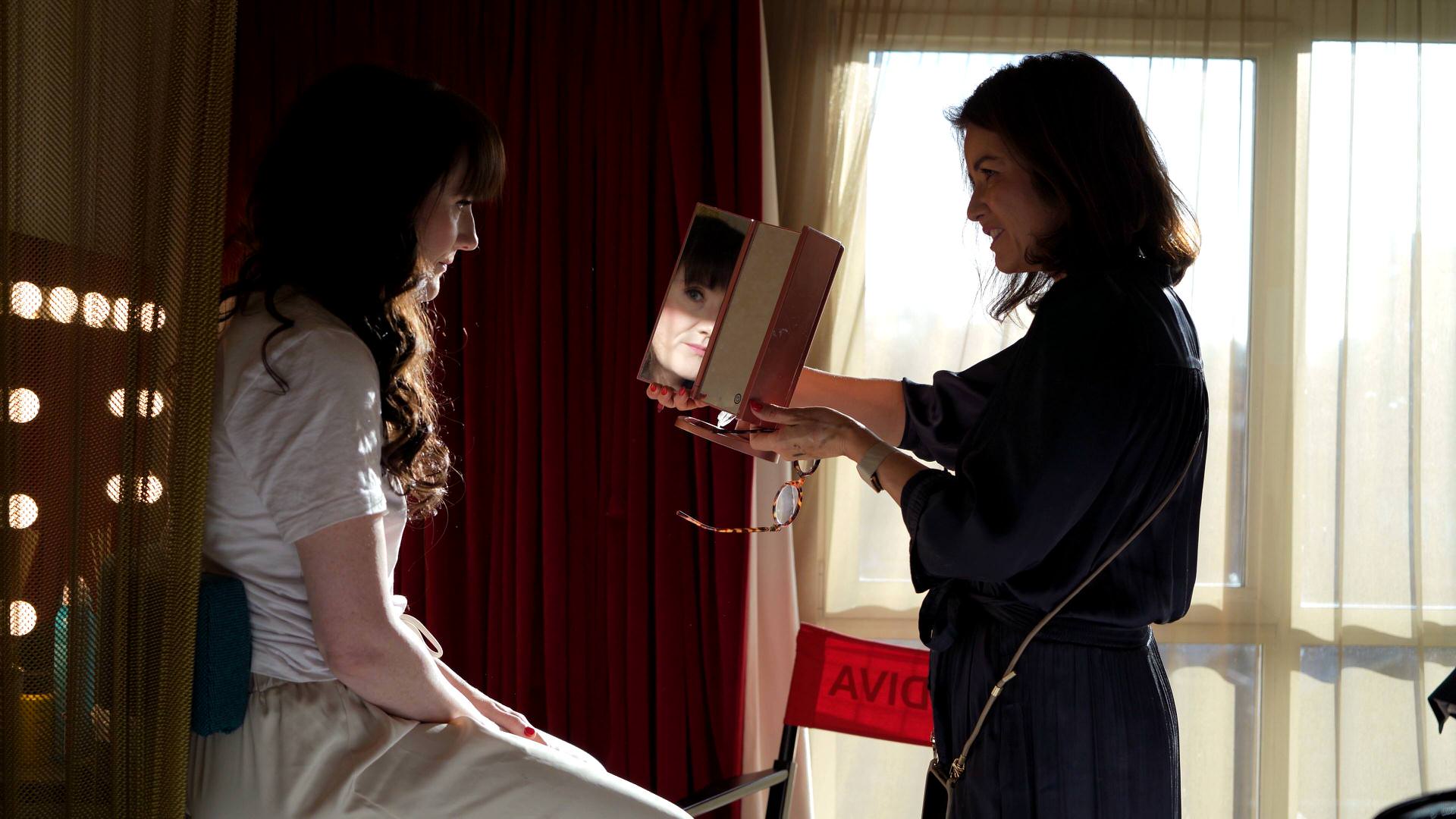 adiehairandmakeup showing the bride the finished look in the mirror in London