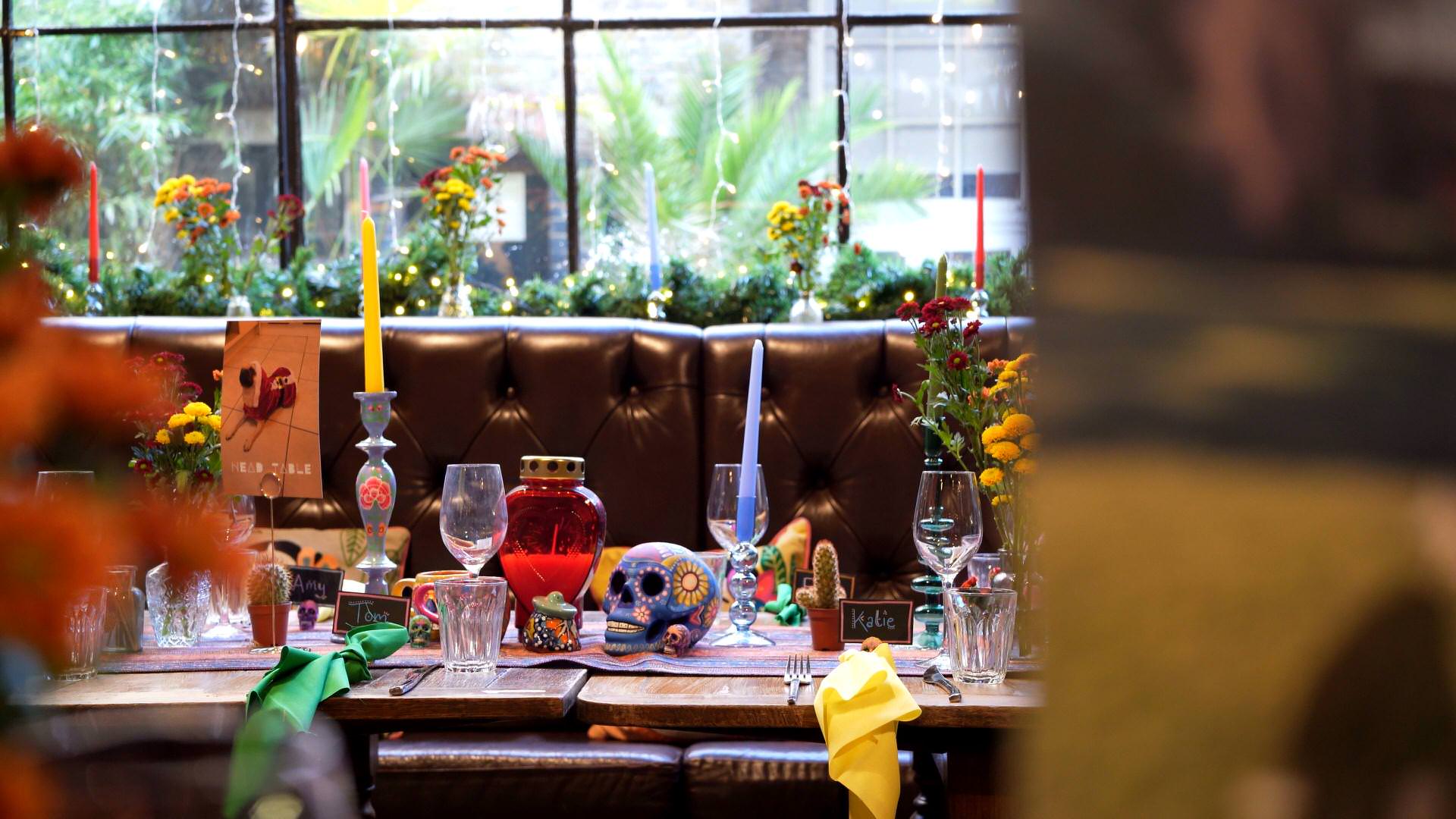 day of the dead colourful skulls sit on the top table