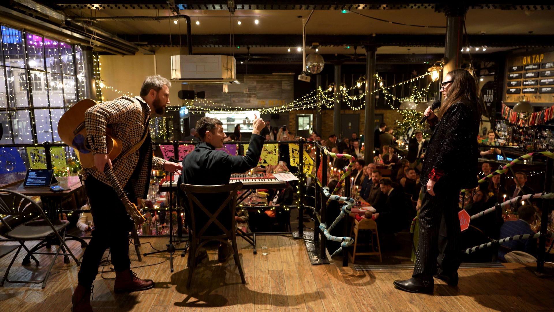 dan from bastille gives the thumbs up before singing for the couple and wedding guests in London