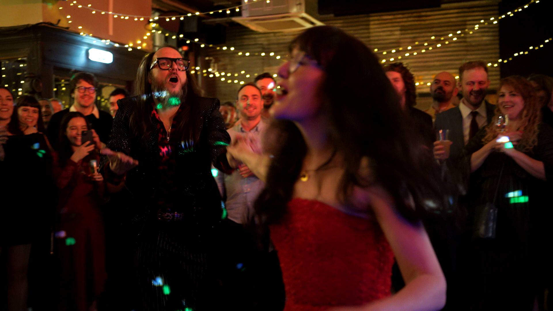 the couple dance and sing during their first dance to Florence and The Machine