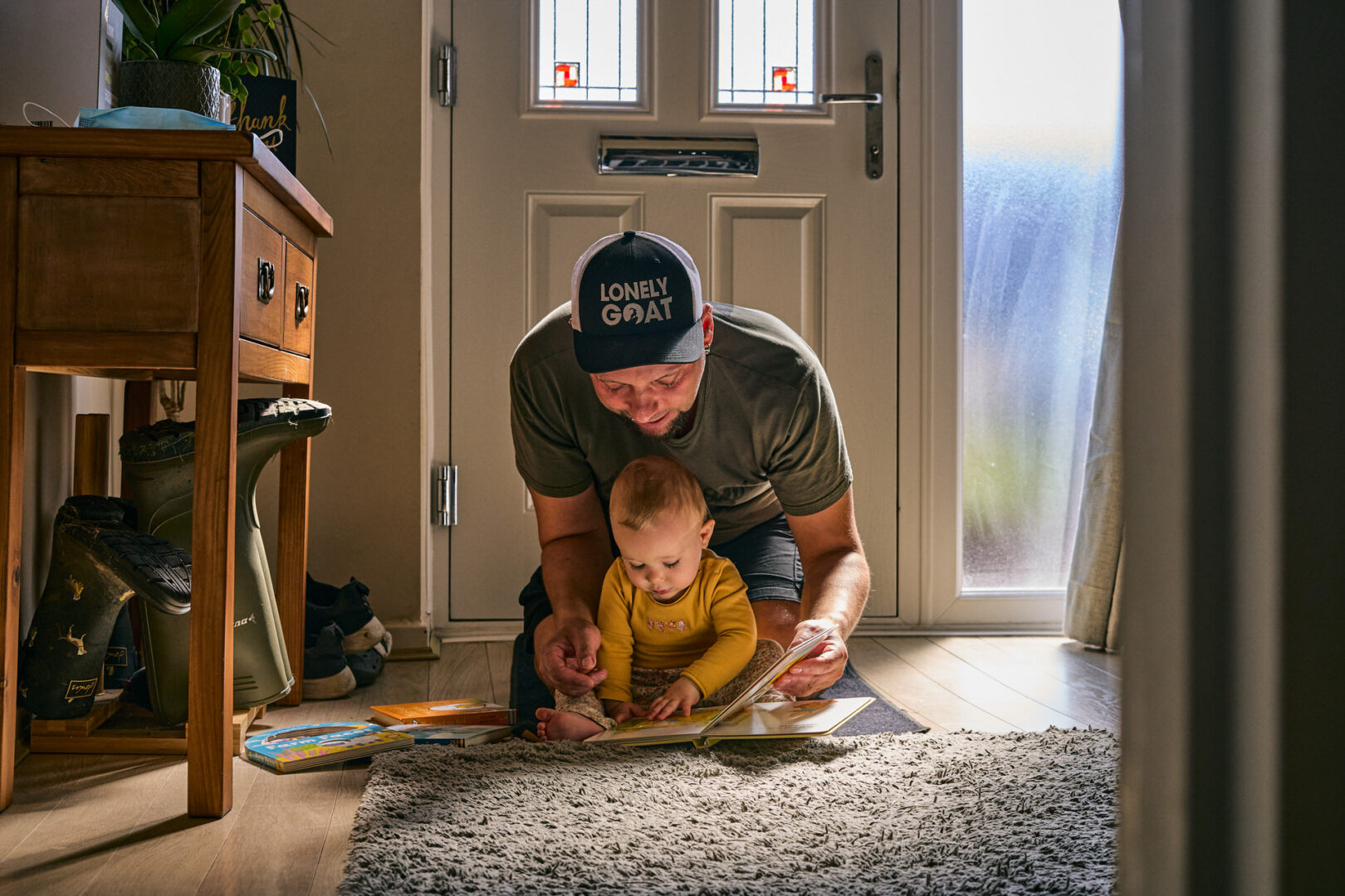 groom sit with his daughter to read on wedding morning in ormskirk