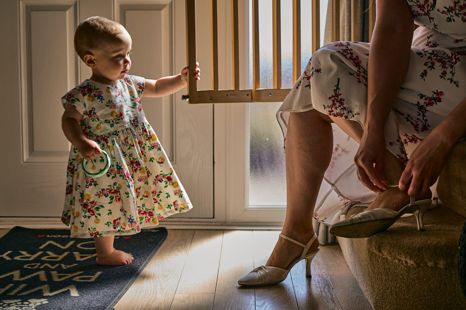 an award winning photo of a little flowergirl watching her mum put on her wedding shoes in Lancashire