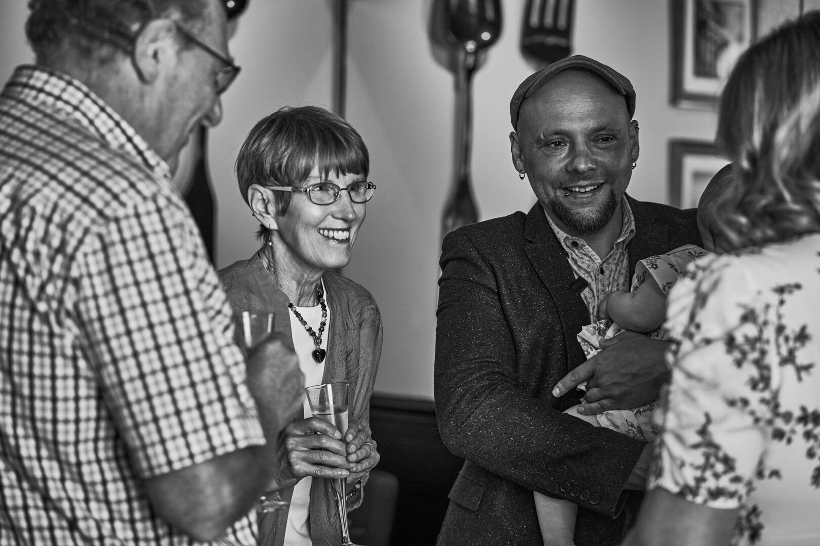 parents laugh with the couple after finding out about their secret wedding in Ormskirk