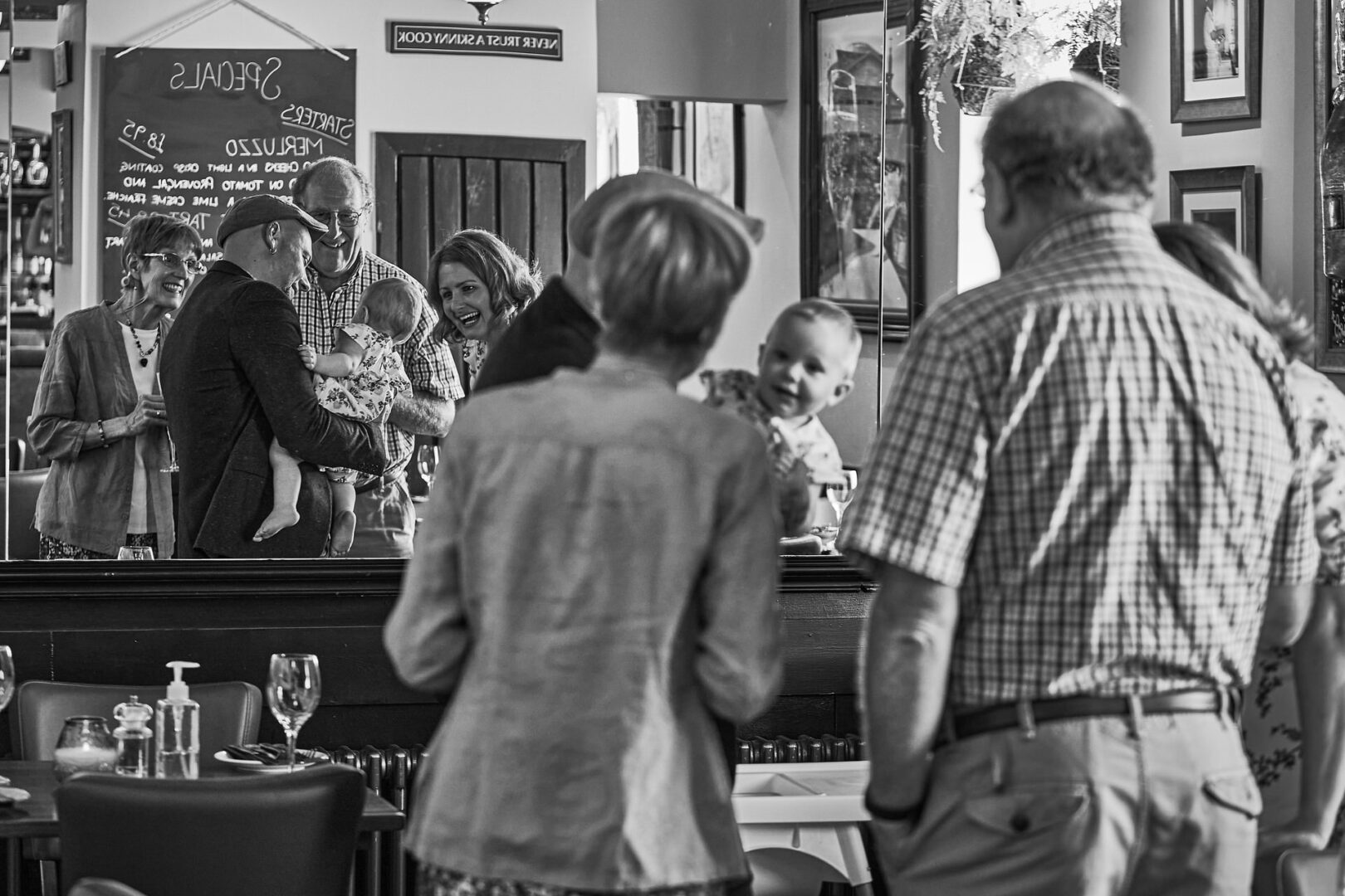 a family enjoy a glass of champagne at The Fat Italian Ormskirk after surprsing her parents to their secret wedding