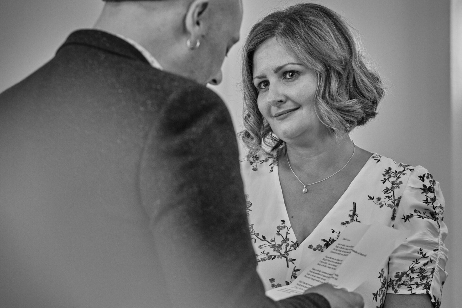 the bride looks at her husband with tears in her eyes for a photo at Ormskirk registry office