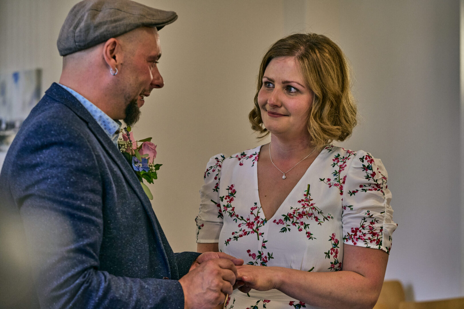 a natural photo of a couple exchanging wedding rings at a small wedding in ormskirk