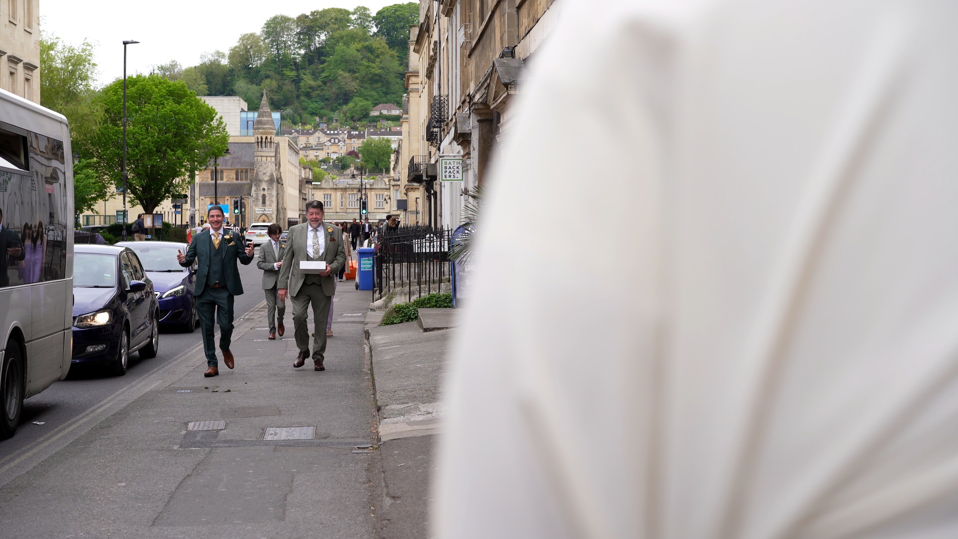 Groom and Dad walk and laugh during candid moment in Bath
