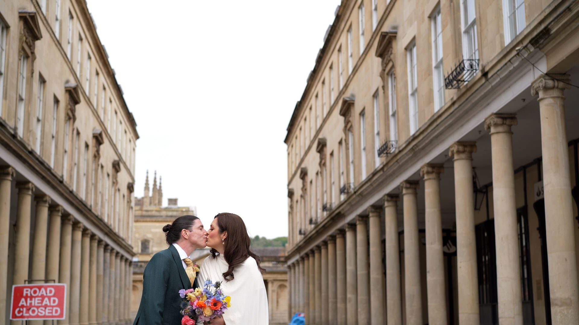 a videographer captures a couple together outside Roman Baths