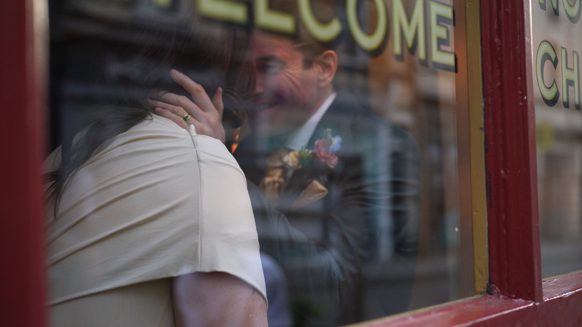 a more creative shot through a reflective glass window of a couple