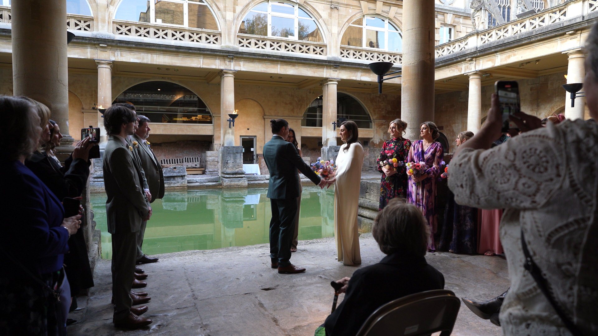 a couple stand by the thermal waters at Roman Baths to say their vows