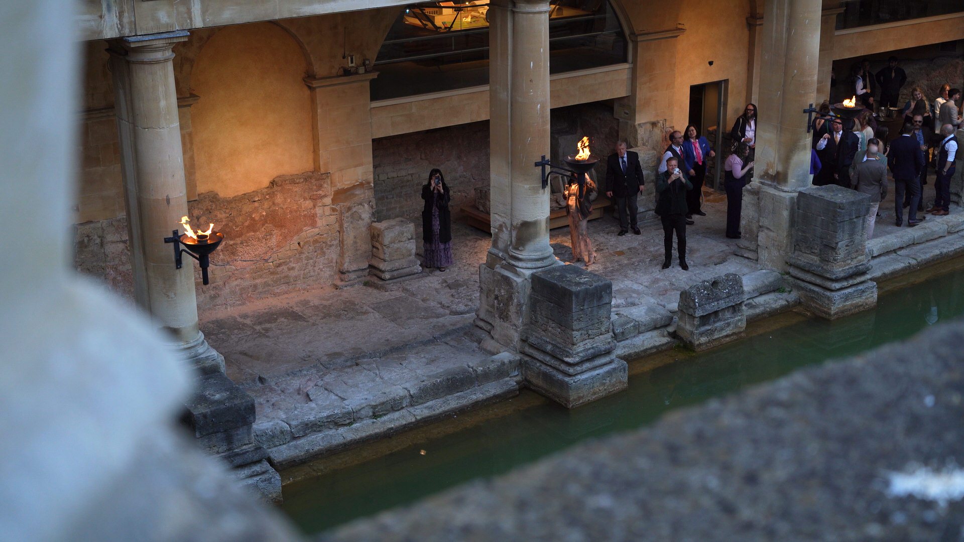a view from the terrace at the roman baths of guests taking photos
