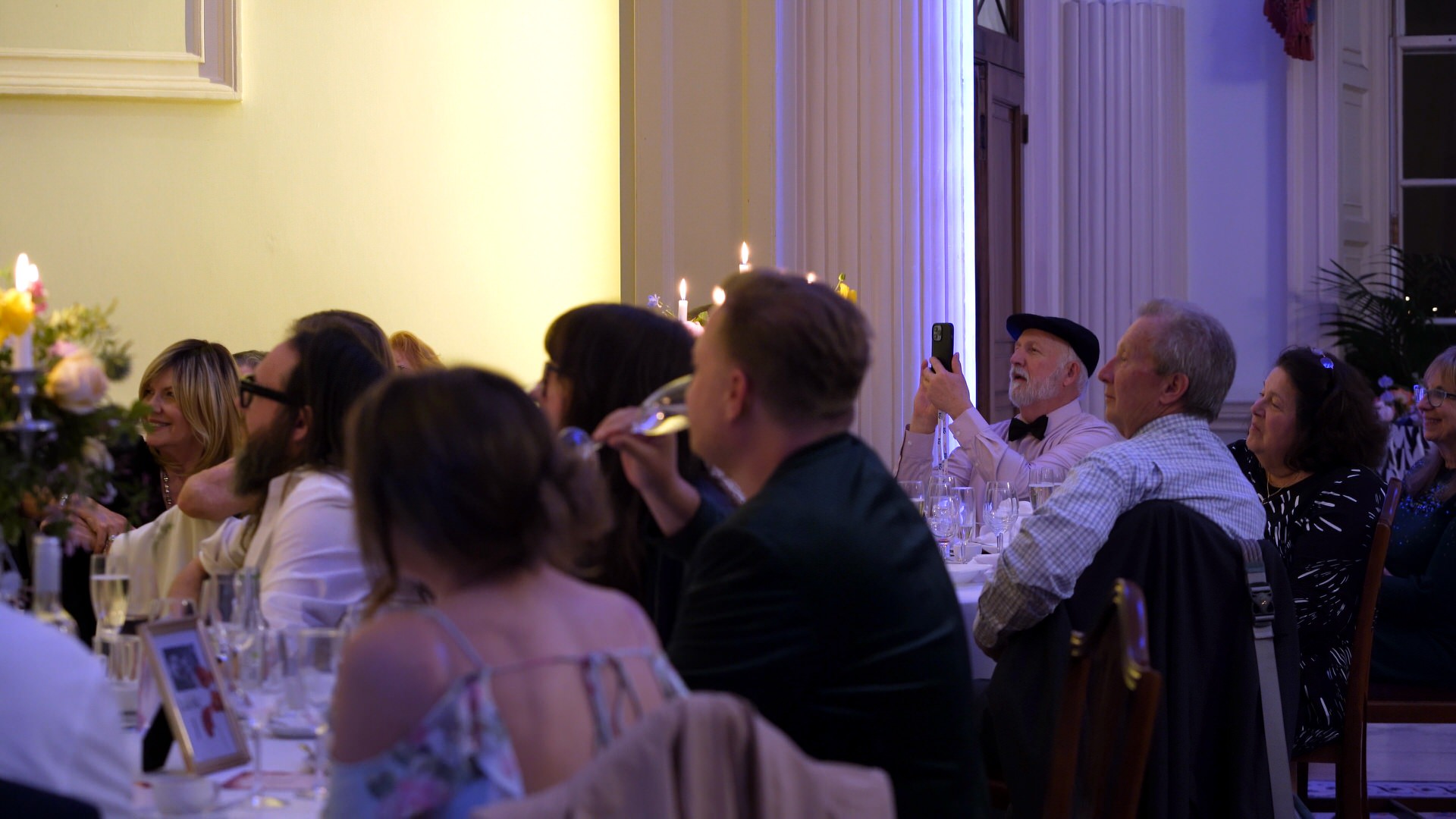 a guest uses his phone to film speeches