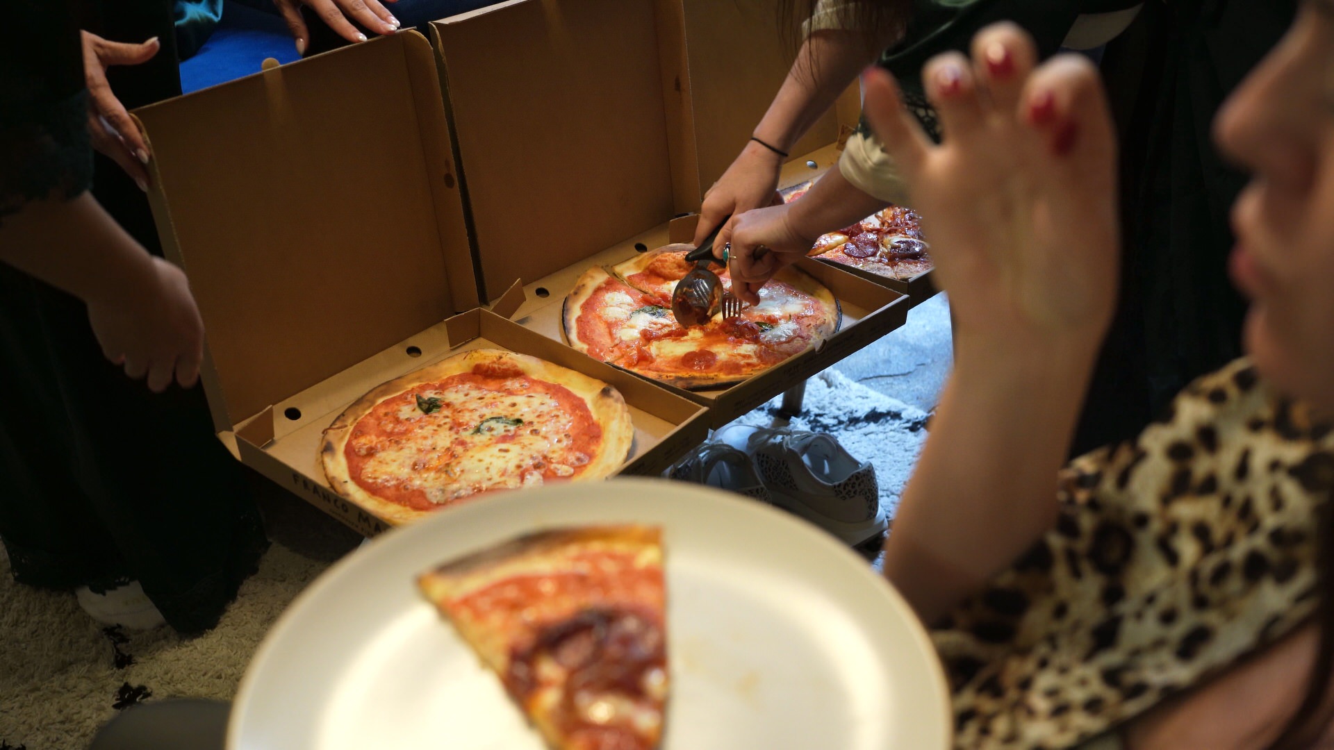 pizza being cut and served whilst getting ready for a vow renewal