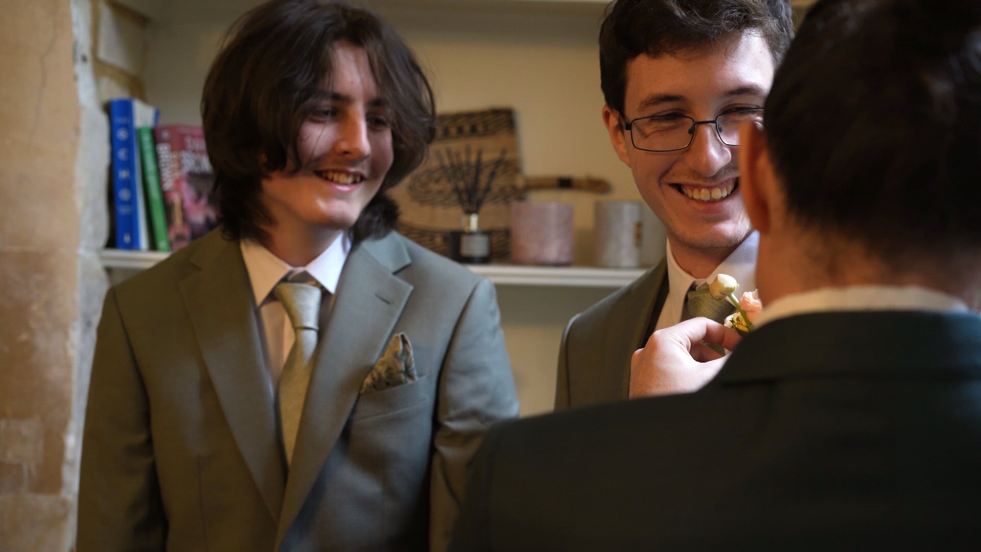 son's laugh with dad whilst getting their button hole on