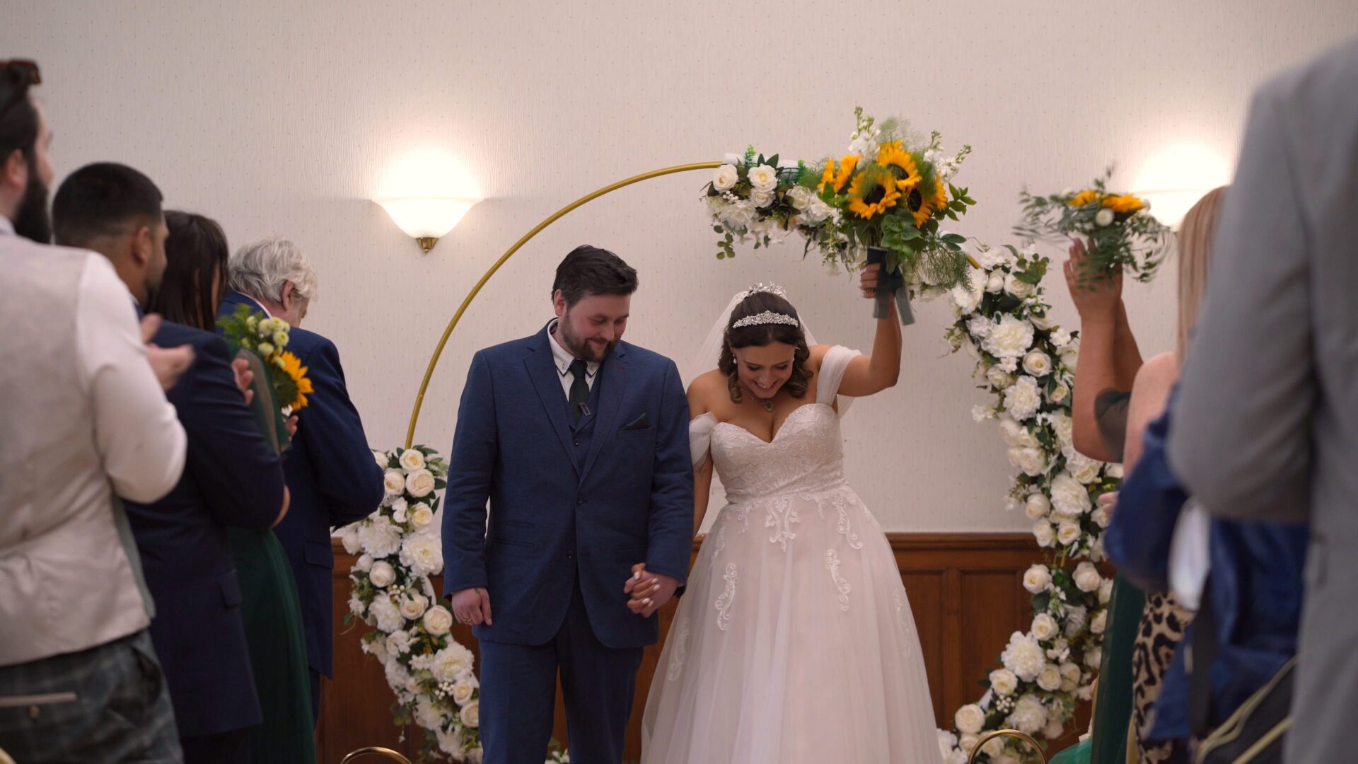 the bride and groom walk down the aisle at Wyre Civic Centre
