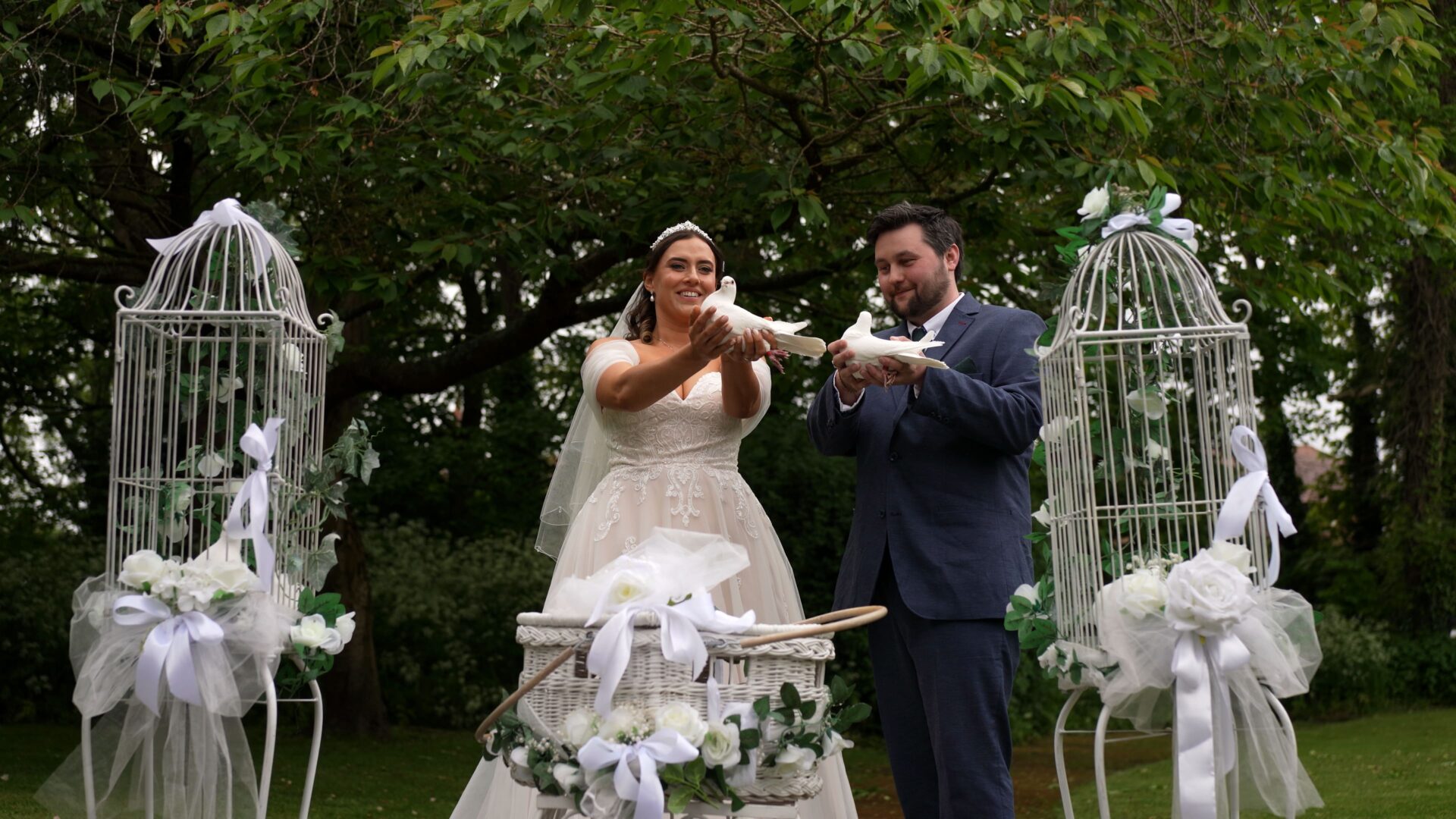 the couple hold a pair of white doves by Does of Life outside Wyre Civic Centre