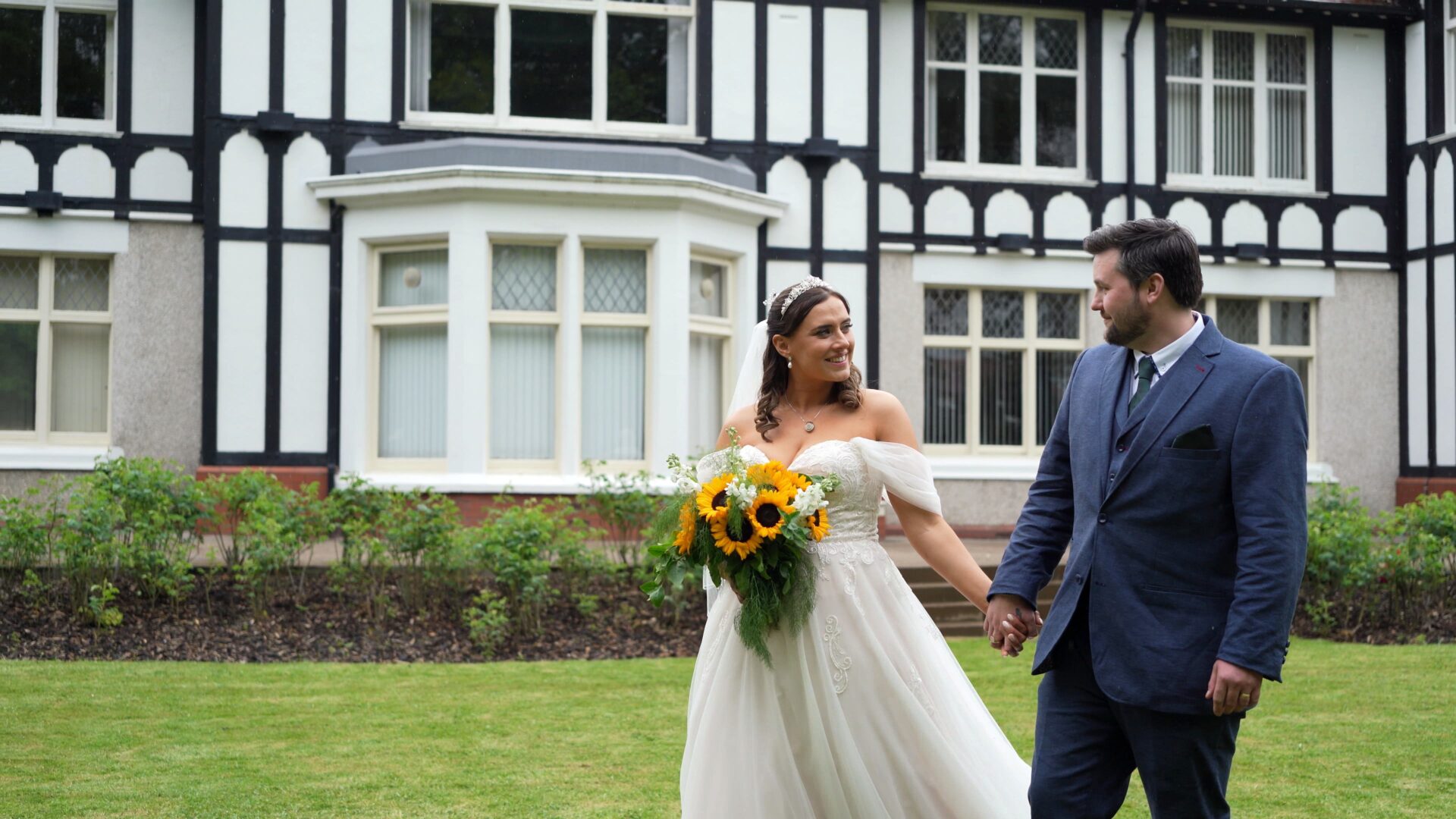newlyweds walk through the gardens at Wyre Civic Centre