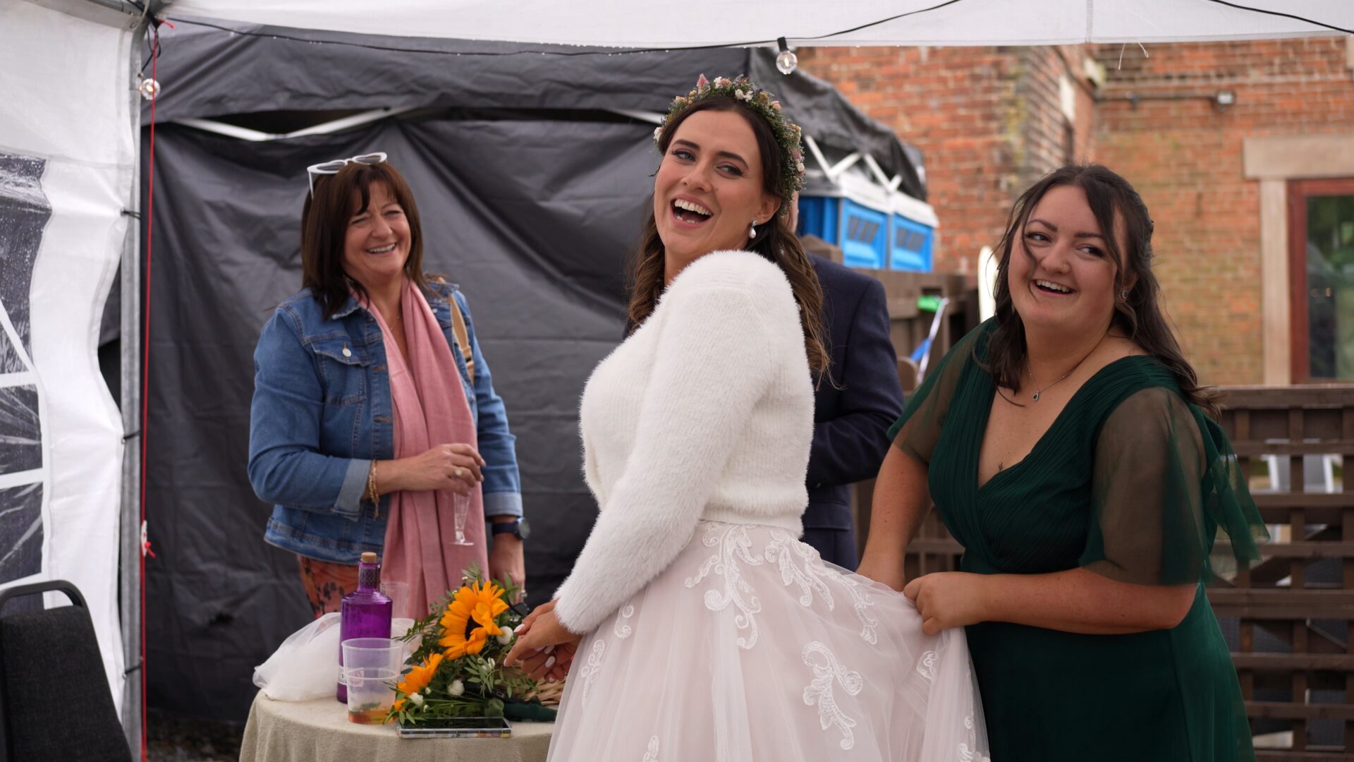 the bride laughs with her mum and bridesmaids during a DIY reception in Poulton-le-Fylde