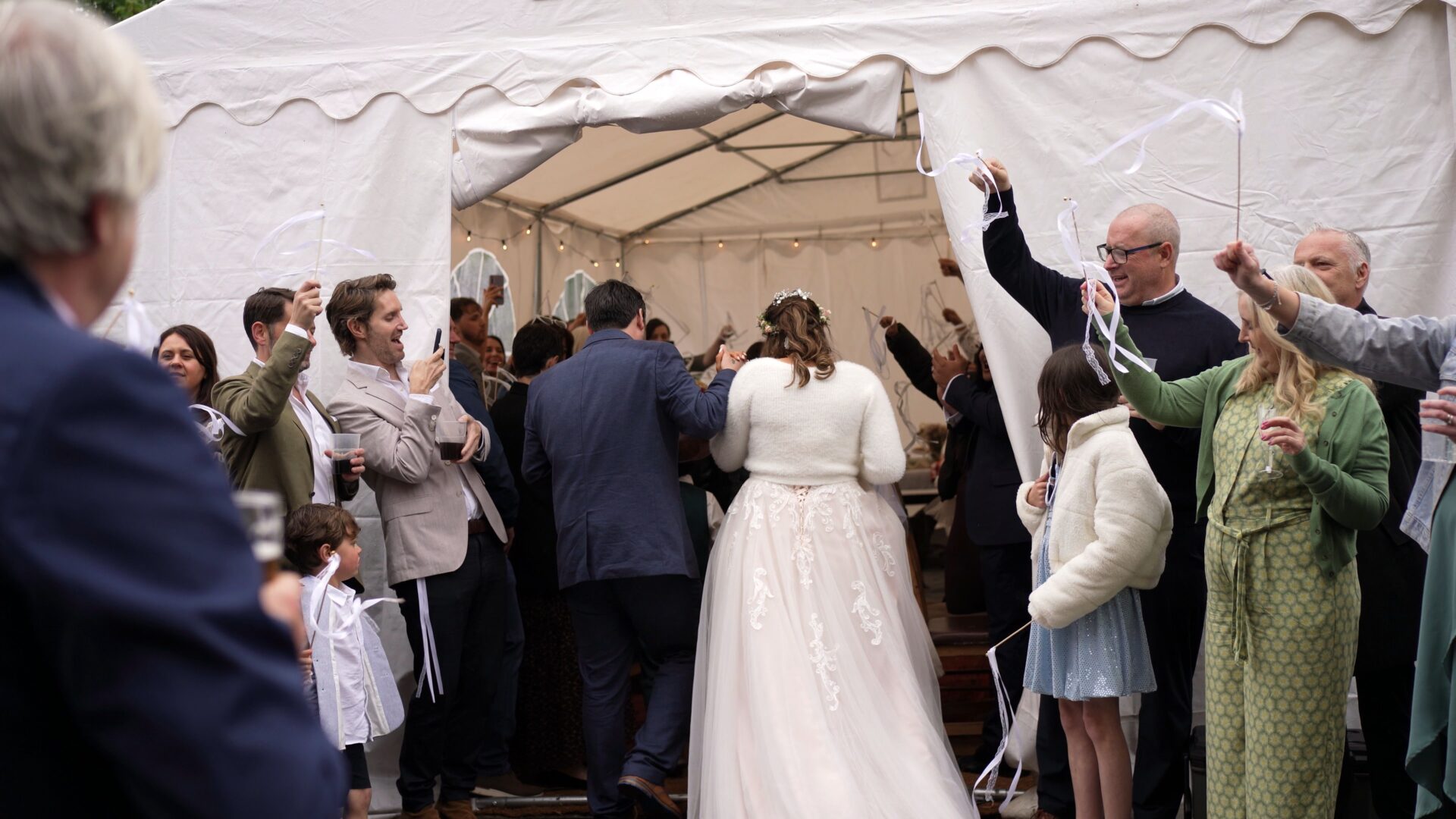 a couple enter their DIY farm marquee reception in Poulton-le-Fylde