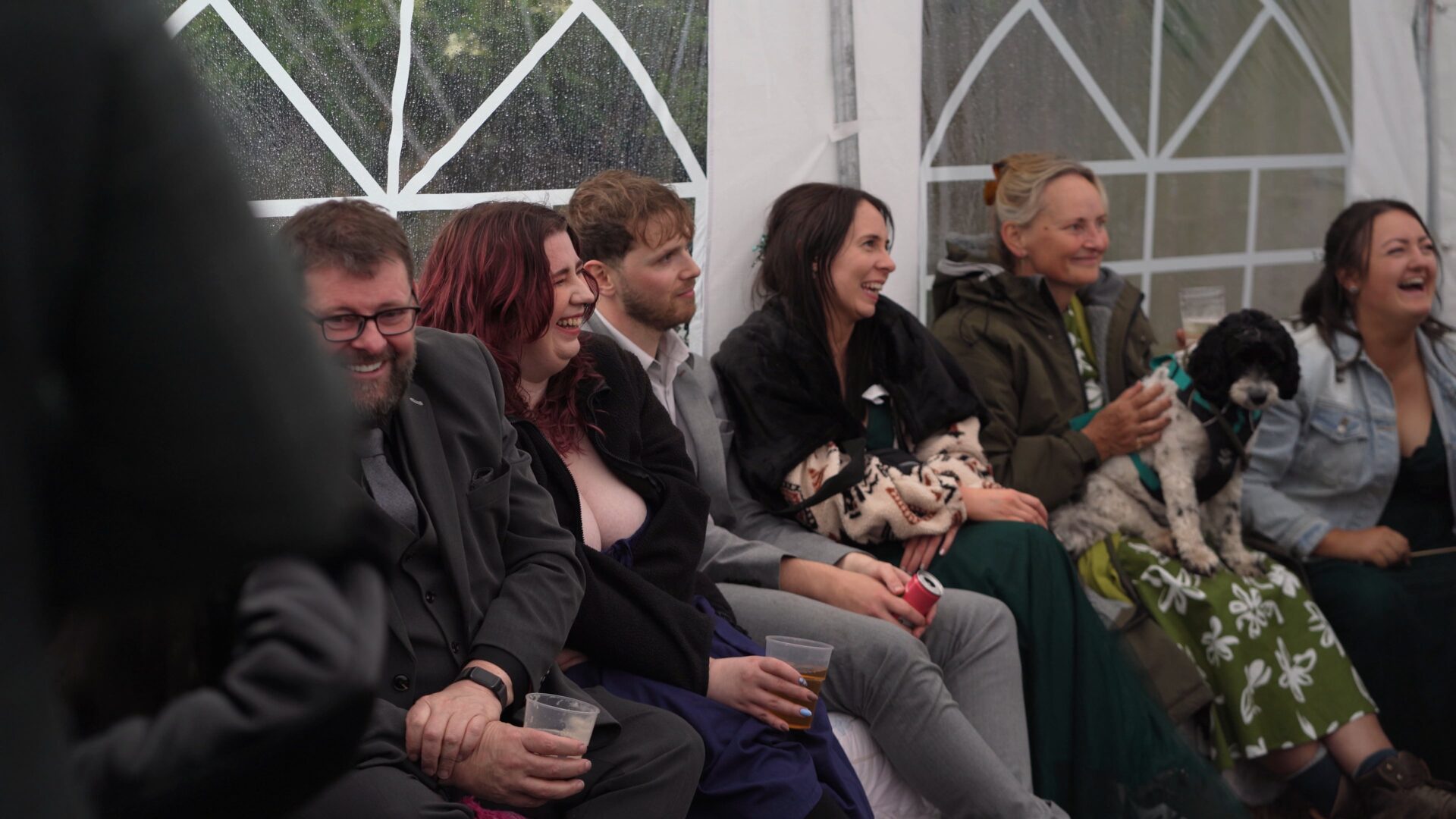 guests huddle in the marquee for the wedding speeches