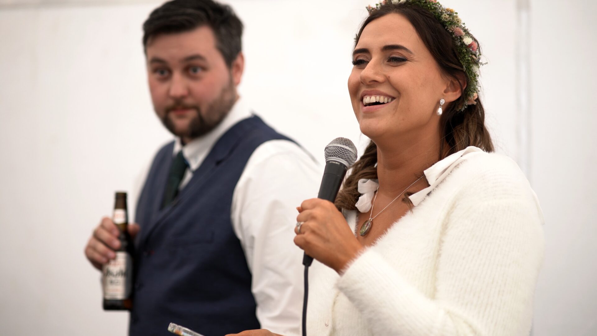 the bride laughs during her own wedding speech during a DIY reception