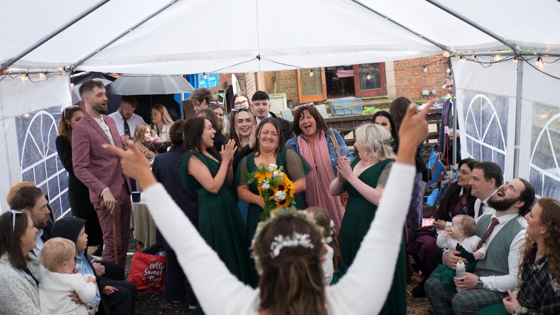 a bridesmaid catches the sunflower wedding bouquet