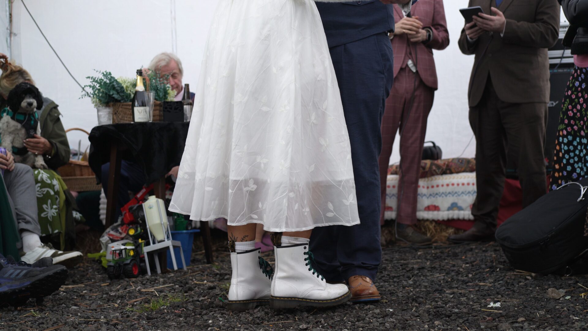 a close up of the brides shorter tea dress and white Dr Martin bridal boots