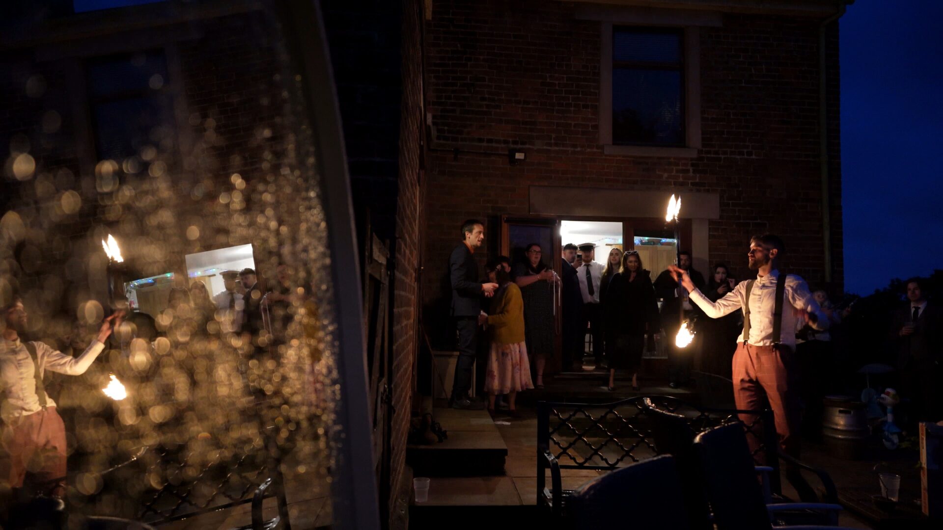 the brides brother does a fire performer routine for guests at this DIY farmhouse wedding in Poulton-le-Fylde Lancashire