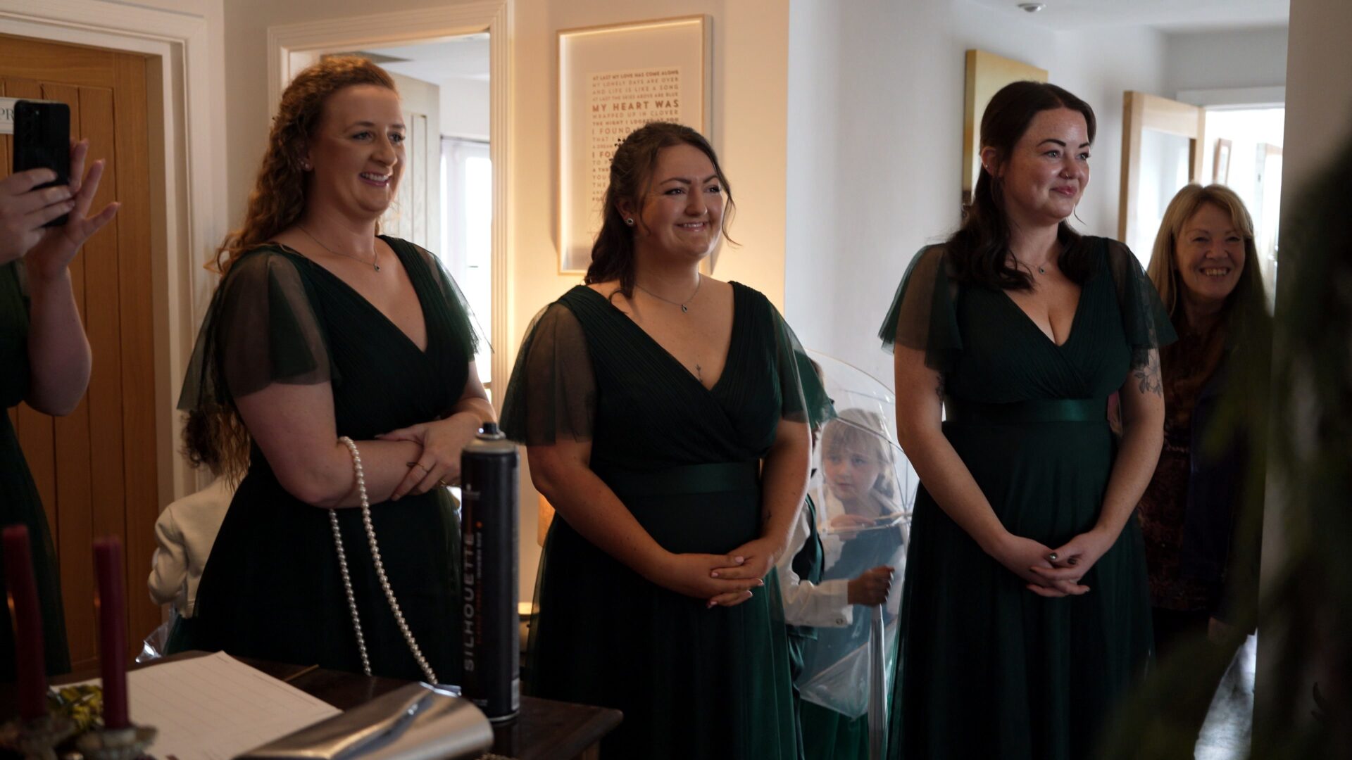 bridesmaids watch on as the bride does a first look with parents
