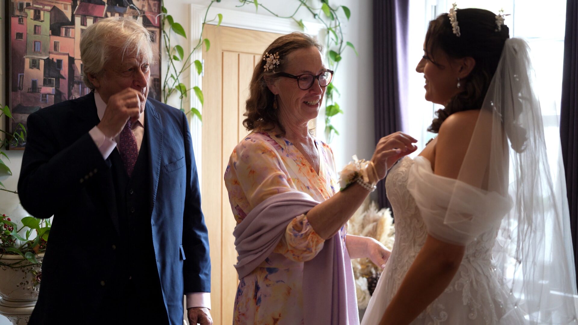 a dad wipes away a tear as the bride does a first look at in Lancashire