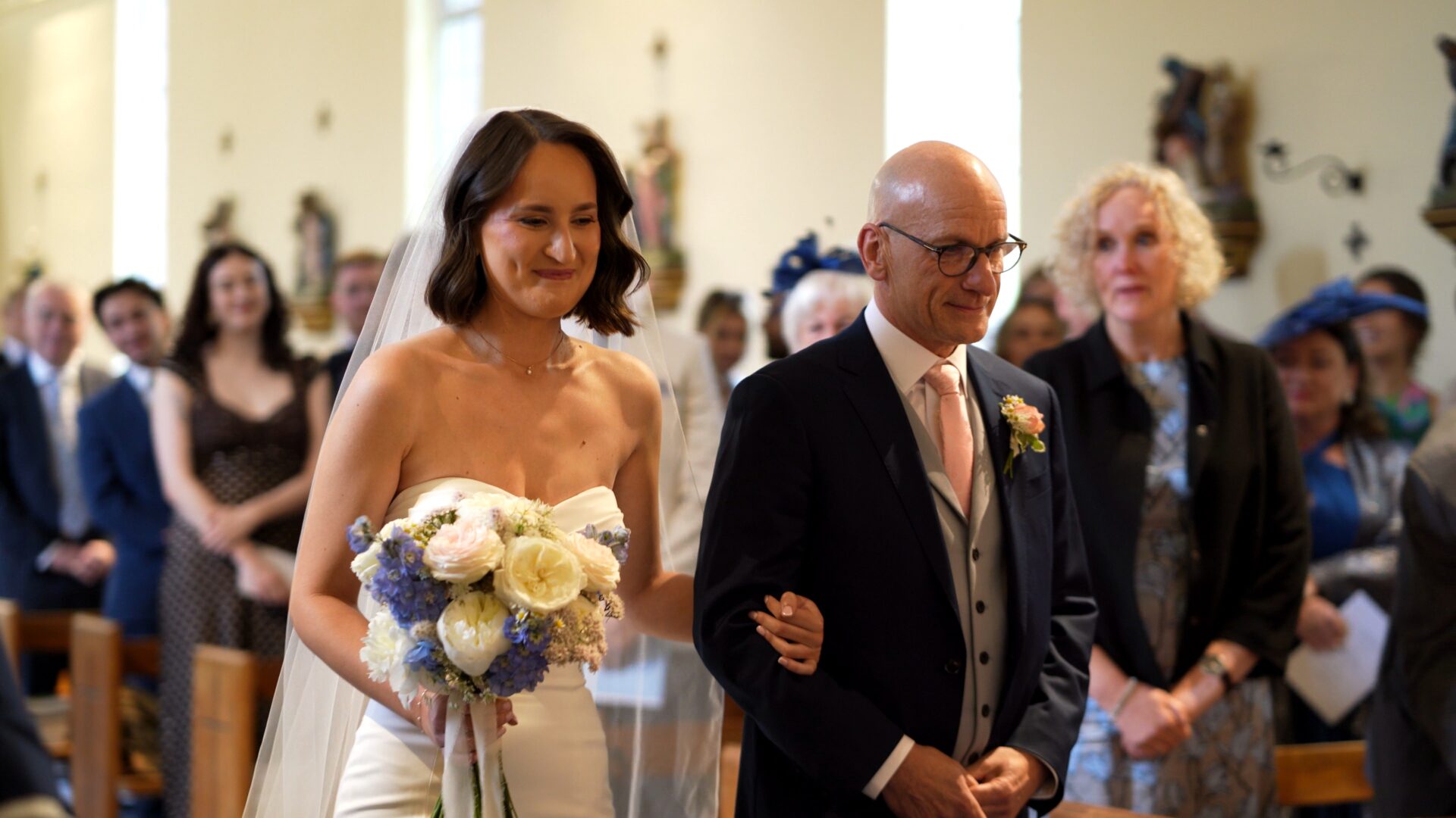 a documentary wedding videographer captures the bride walking down the aisle during a ceremony at St. Aelred's Catholic Church Harrogate