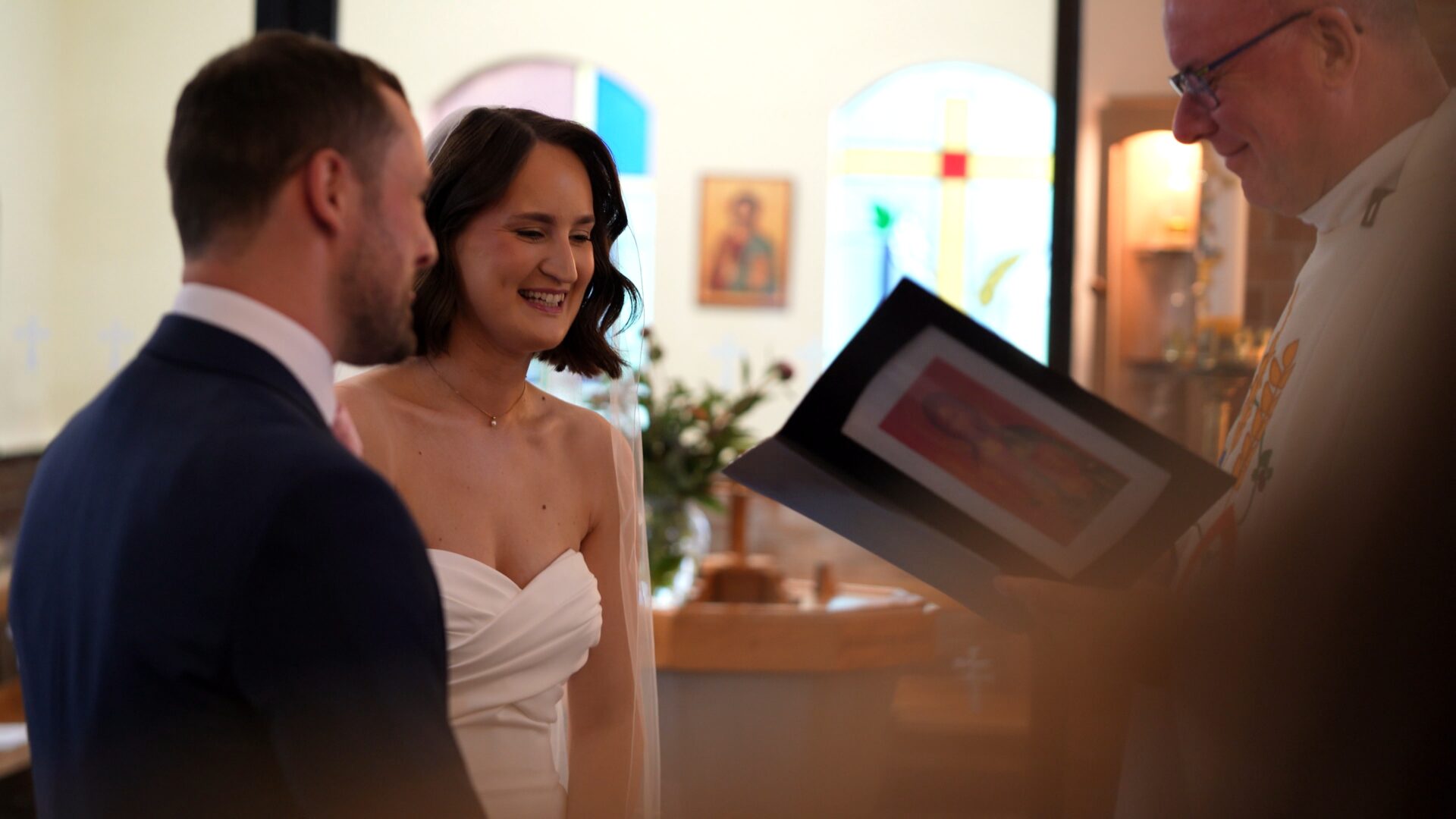 the couple smile during a relaxed moment in their wedding ceremony in Harrogate