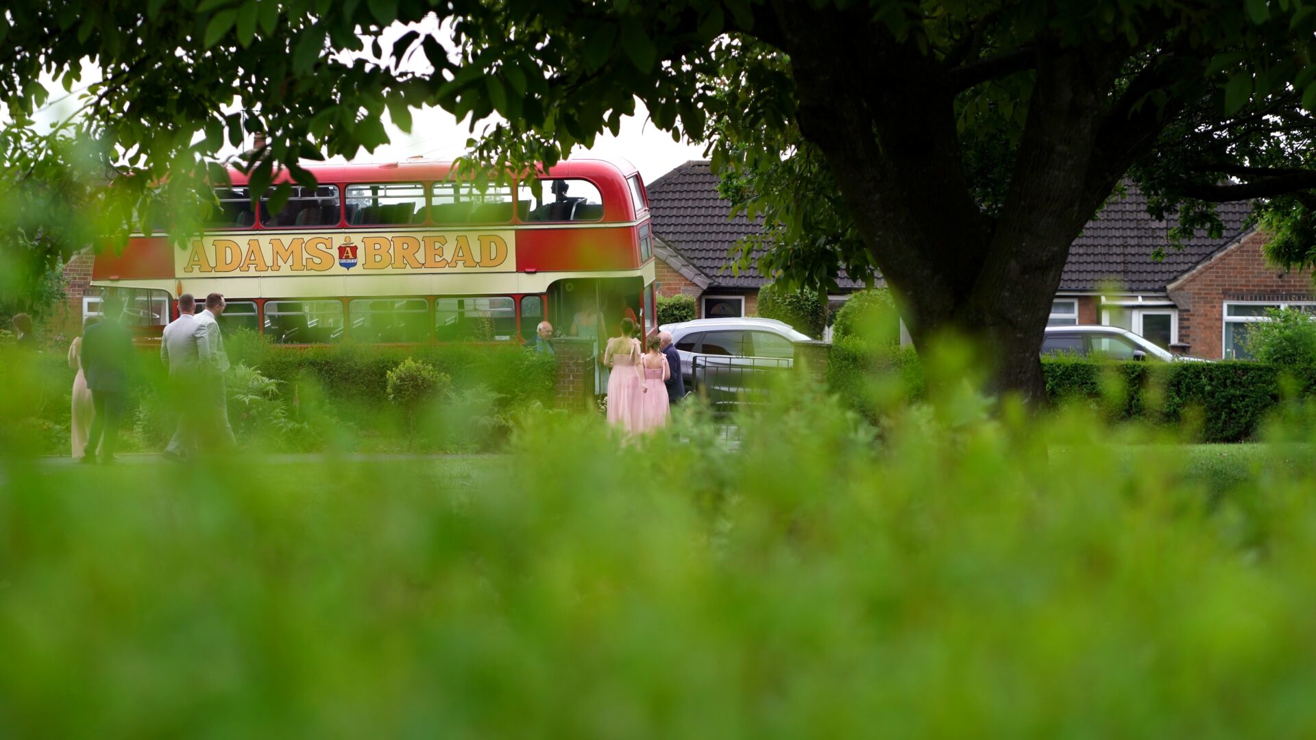 a documentary storytelling shot of guests walking to their vintage wedding bus after a ceremony in Harrogate