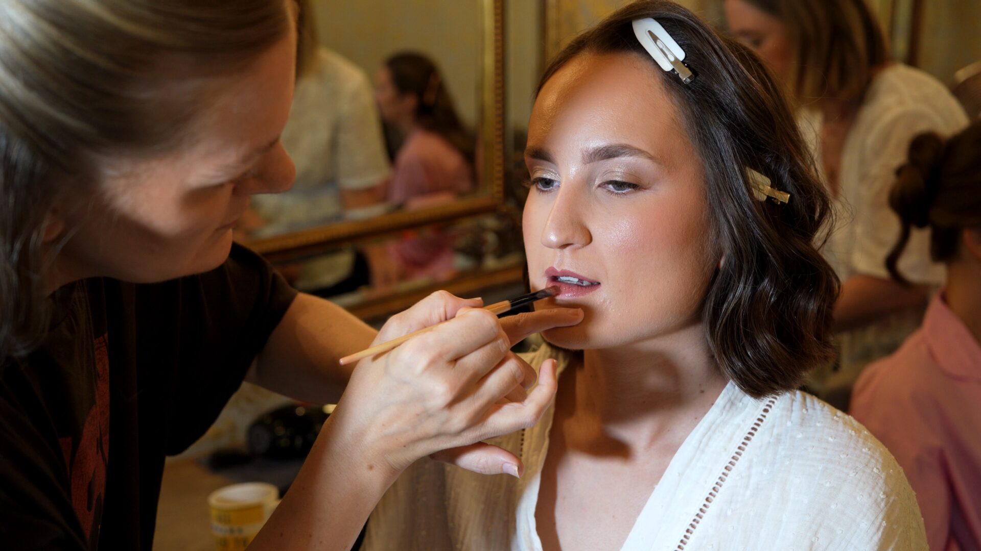Candid documentary style wedding videography of a bride getting her makeup done during a rainy morning prep at Wharfedale Grange.