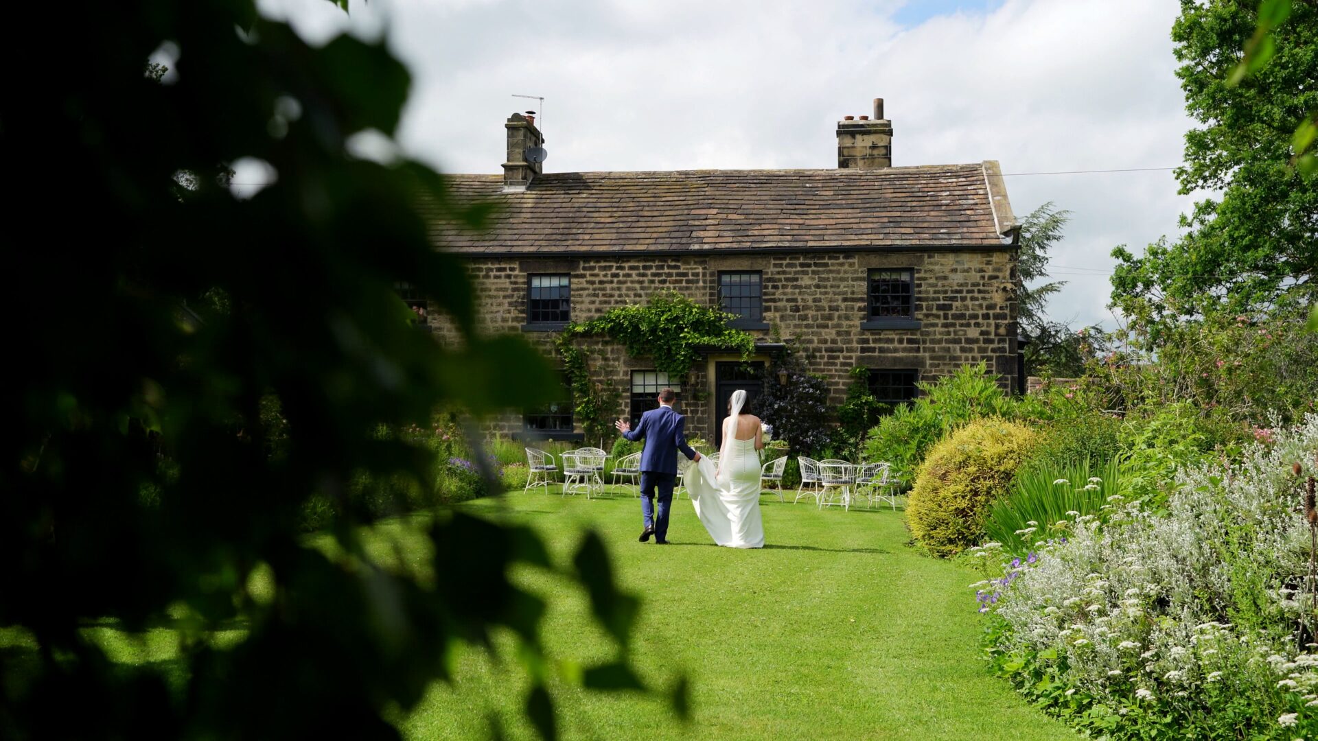 a candid documentary wedding videographer captures a rare moment of just the couple enjoying the gardens at Wharfedale Grange in Yorkshire