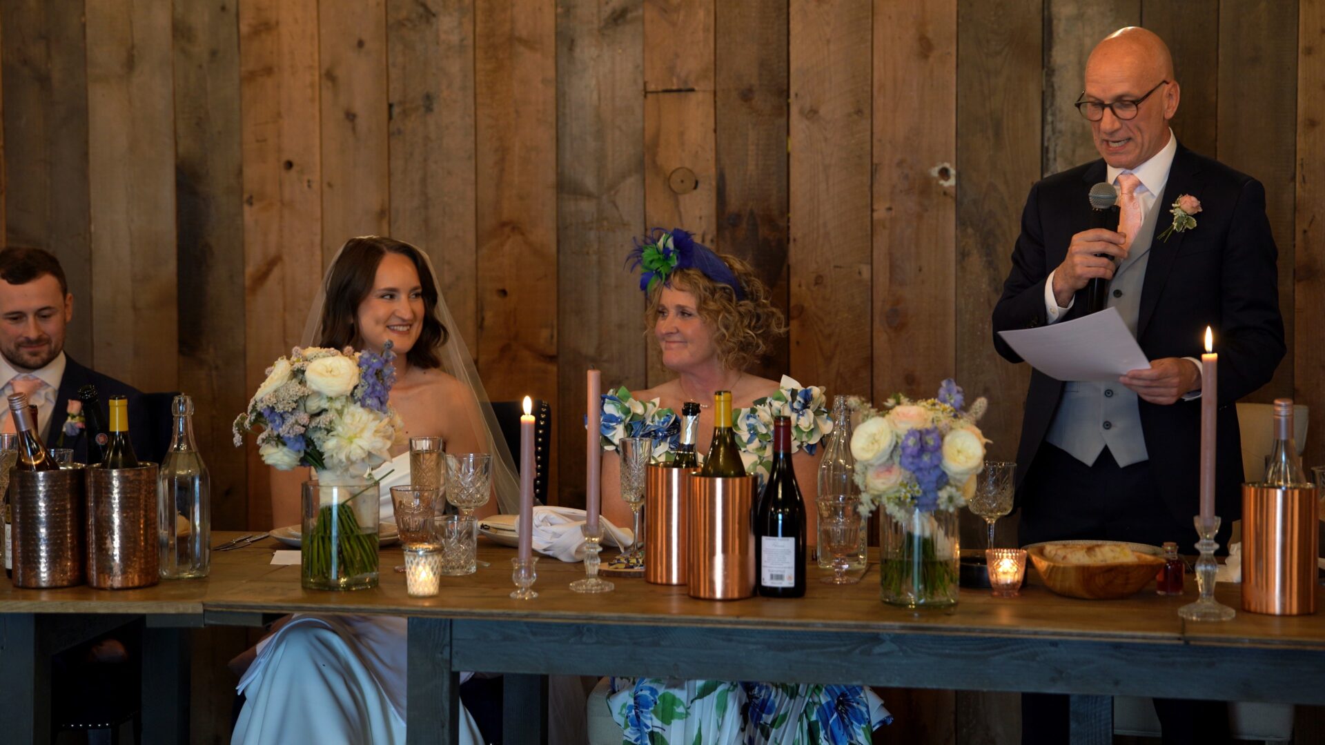 a father of the bride delivers his speech inside the rustic luxury wedding barn at Wharfedale Grange