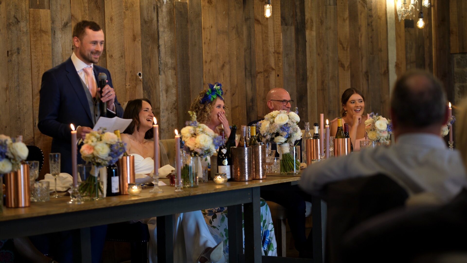 the top table laugh during the Grooms speech at a wharfedale grange wedding reception